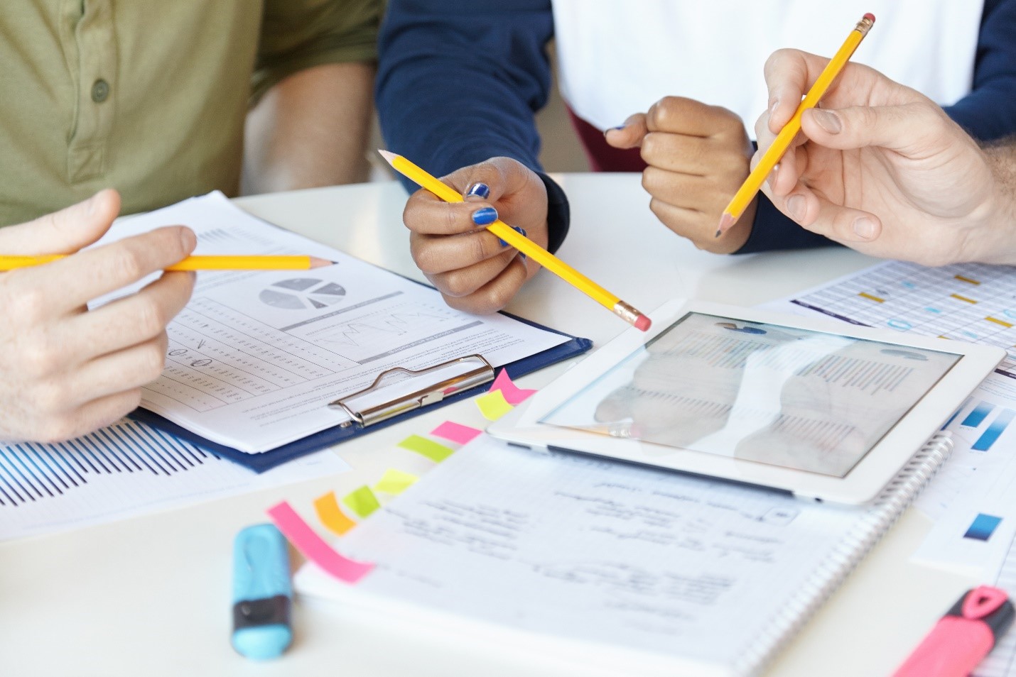 Researchers putting together elements of a poster proposal