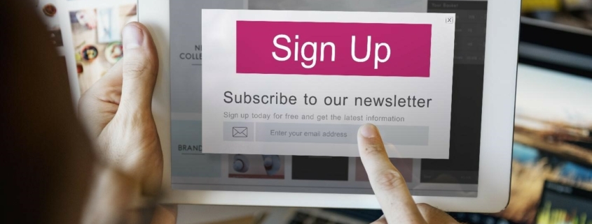 A person using a tablet to sign up for a newsletter, highlighting the importance of easy subscription processes.